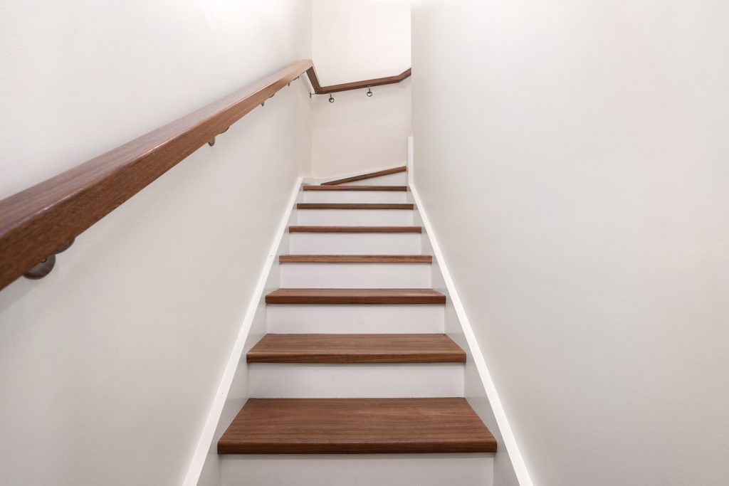 Completed internal staircase with timber treads and handrail