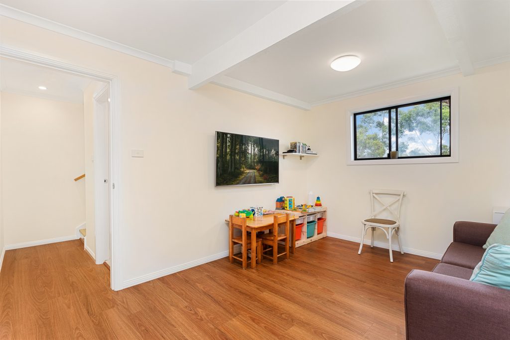 Living and play area with a television, seating and toy storage