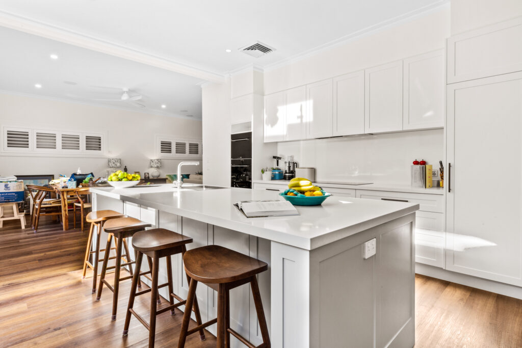 Modern home renovation with custom kitchen, stone island bench and open-plan living area